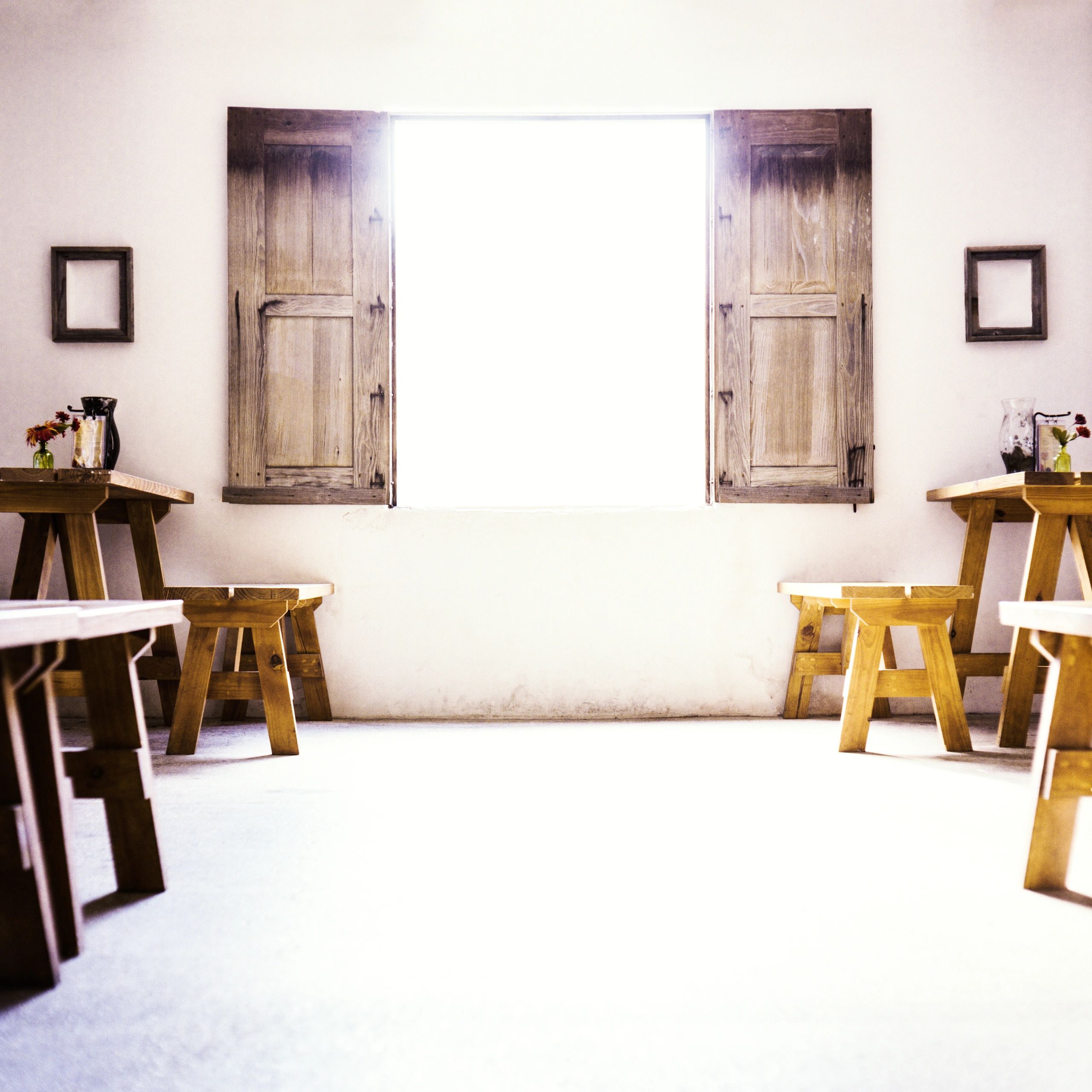 Minimalist rustic interior with wooden furniture and shutters