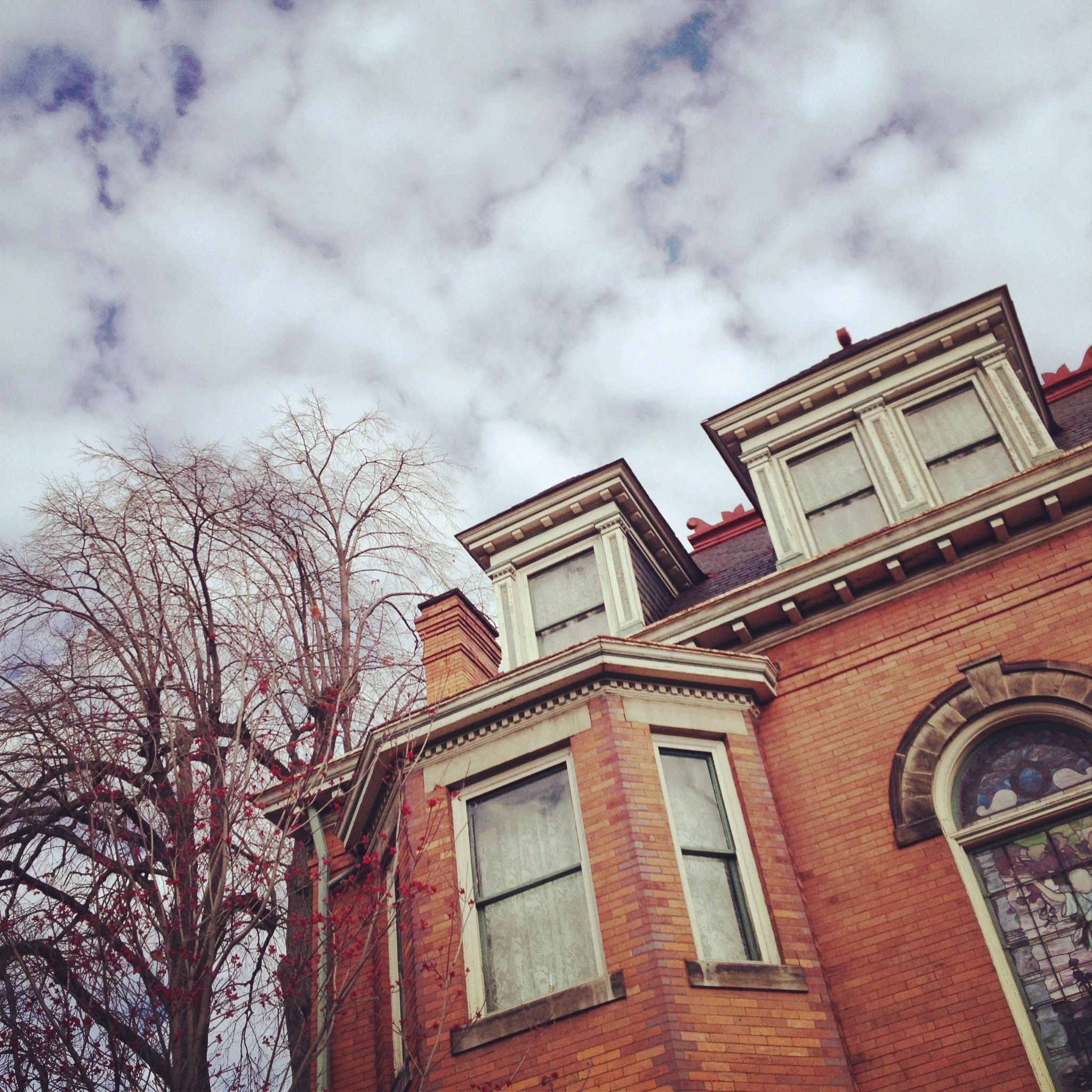 Victorian red brick building with ornate mansard roof